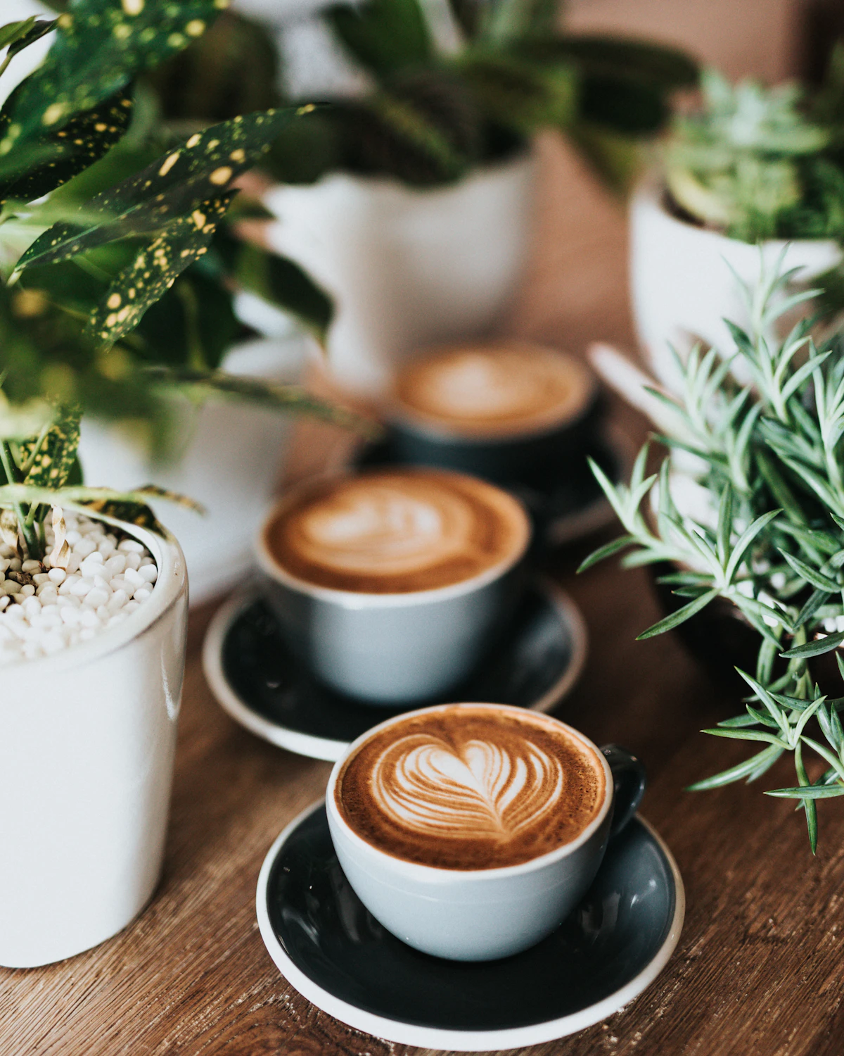 Latte in a ceramic cup on a warm wood table